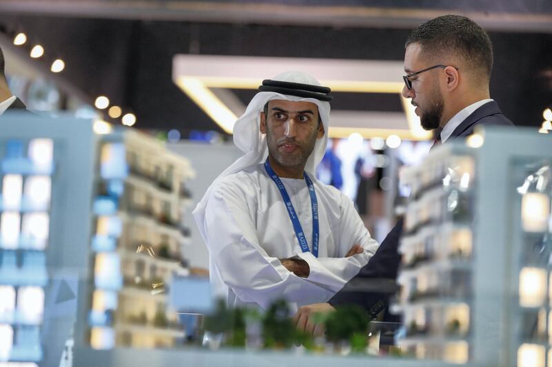 Abu Dhabi, UAE,  April 17, 2018.  
CITYSCAPE Abu Dhabi 2018.  A CITYSCAPE Visitor takes interest in one of the property displays.
Victor Besa / The National
National
Reporter:  Sarah Townsend
