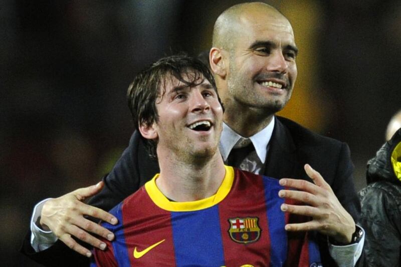Incoming Manchester City manager and former Barcelona head coach Pep Guardiola shown with Lionel Messi after a Champions League match in May 2011. Javier Soriano / AFP