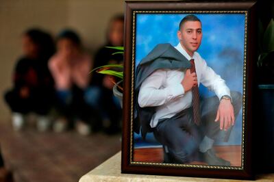 A picture of Palestinian Salah Omar Barghoutzi is seen framed at his family house in the West Bank city of Ramallah on December 13, 2018. 


  Israeli security forces today shot dead Barghoutzi, suspected of the shooting of seven Israelis including a pregnant woman whose baby later died. The Shin Bet security service said in a statement that a suspect named as Salah Omar Barghoutzi who tried to evade capture during a raid on a West Bank village was shot and killed.
 / AFP / ABBAS MOMANI
