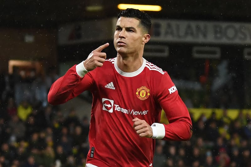 Manchester United's Portuguese striker Cristiano Ronaldo celebrates after scoring the opening goal from the penalty spot during the English Premier League football match between Norwich City and Manchester United at Carrow Road Stadium in Norwich, eastern England, on December 11, 2021.  (Photo by Daniel LEAL / AFP) / RESTRICTED TO EDITORIAL USE.  No use with unauthorized audio, video, data, fixture lists, club/league logos or 'live' services.  Online in-match use limited to 120 images.  An additional 40 images may be used in extra time. AFP