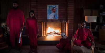 The Wilson family doppelgängers (from left) Abraham (Winston Duke), Umbrae (Shahadi Wright Joseph), Pluto (Evan Alex) and Red (Lupita Nyong’o) in "Us," written, produced and directed by Jordan Peele. Courtesy Universal Pictures