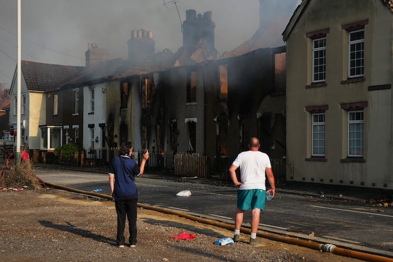 Residents look at buildings destroyed by fire in Wennington. Getty