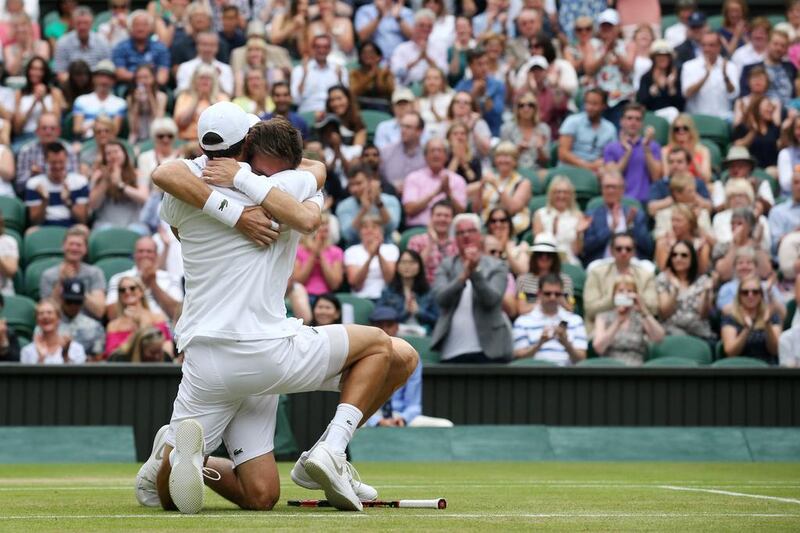 France’s Pierre-Hughes Herbert, left, and Nicolas Mahut, right, embrace as they celebrate beating France’s Julien Benneteau and Edouard Roger-Vasselin to win the men’s doubles final on the thirteenth day of the 2016 Wimbledon Championships at The All England Lawn Tennis Club in Wimbledon, southwest London, on July 9, 2016. Justin Tallis / AFP