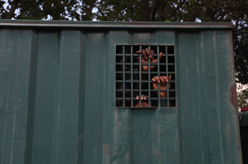 Recaptured inmates inside a prison vehicle. AFP