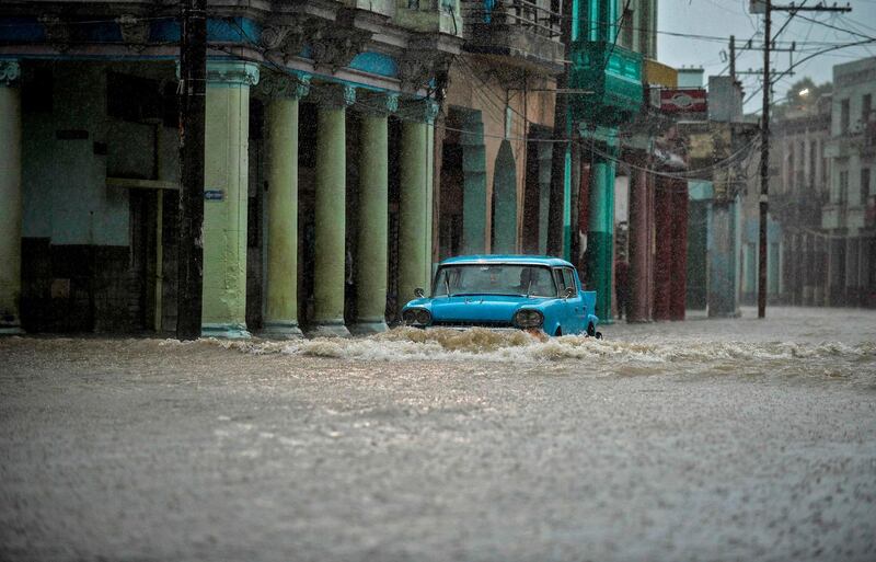 A car drives along a flooded street at the 10 de Octubre municipality in Havana, Cuba. AFP