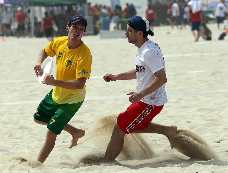 Australia (Green) and Russia (White) in action during the 2015 World Championships of Beach Ultimate (WCBU) at the JBR beach in Dubai. Satish Kumar / The National