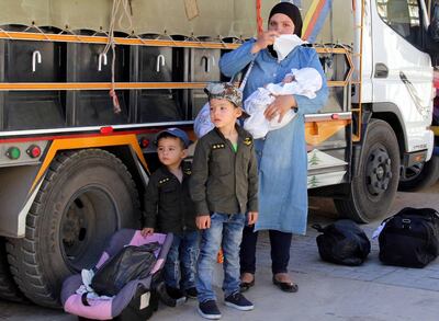 Syrian refugees gather their belongings as they prepare to be evacuated from the southern Lebanese village of Shebaa on August 13, 2018. - Lebanon says it currently hosts some 1.5 million Syrian refugees, of whom fewer than one million are registered with the UN. (Photo by Ali DIA / AFP)