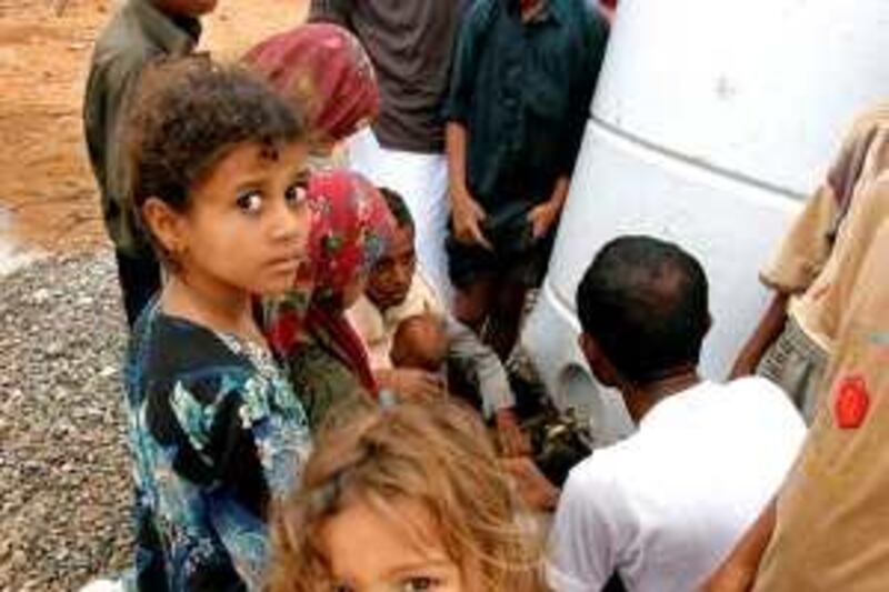 Yemeni children gather near a water tank at the Internally Displaced People's (IDP) camp of Mazraq in northern Yemen on February 22, 2010. One hundred and eighty-seven children have been killed since August 2009 in the conflict in north Yemen, a report by the local SEYAJ children's rights organisation and the UN Children's Fund said. The report also accused both north Yemen Shiite rebels and a pro-government militia of using child soldiers. AFP PHOTO/STR *** Local Caption ***  929431-01-08.jpg *** Local Caption ***  929431-01-08.jpg