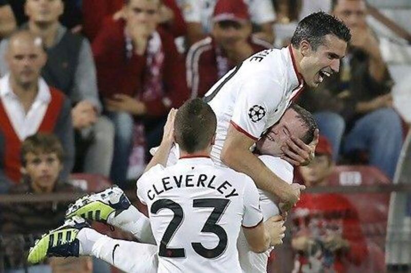 Robin van Persie, centre, celebrates his second goal with Wayne Rooney.