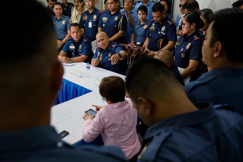 Philippine National Police Director General Ronald Dela Rosa talks to three police officers accused of raping a woman during an anti-drug operation in Bulacan Province, north of Manila. Rolex dela Pena / EPA