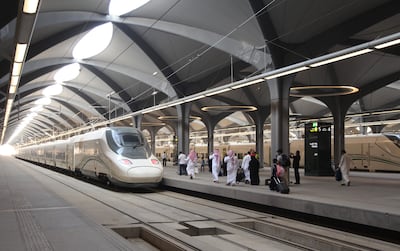 Saudi passengers walk in the platform at Mecca's train station on October 11, 2018 as the new high-speed railway line linking Mecca and Medina opens. The Haramain High Speed Rail system will transport Muslim pilgrims, as well as regular travellers, 450 kilometres (280 miles) between the two cities via the Red Sea port of Jeddah in two hours. Thirty-five passenger trains capable of travelling at speeds of 300 kilometres per hour will slash the travel time from several hours to 120 minutes, transport officials said. The rail project, dogged by several delays, was built at a cost of more than $16 billion, according to Saudi media.
 / AFP / BANDAR ALDANDANI
