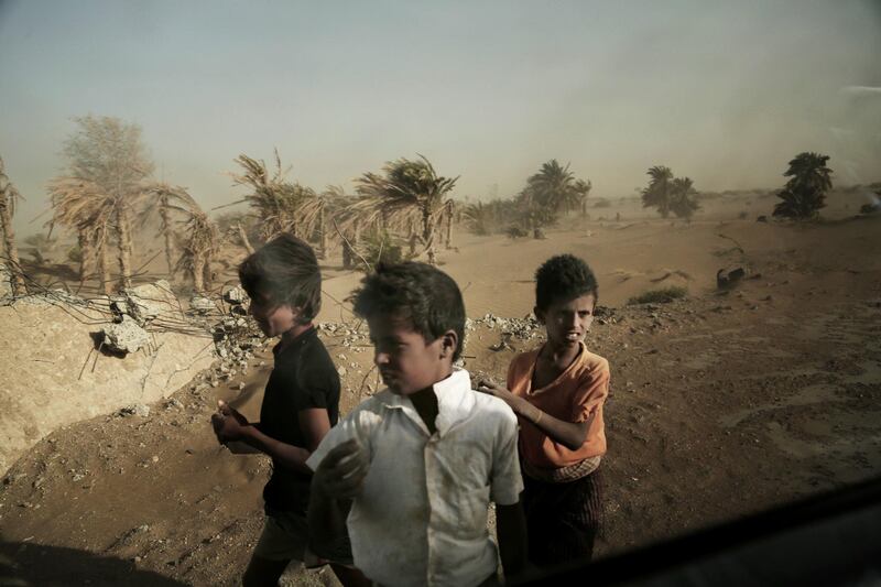 FILE - In this Feb. 12, 2018 file photo, homeless children stand on the road in Hodeida, Yemen. With US backing, the United Arab Emirates and its Yemeni allies have restarted their all-out assault on Yemenâ€™s port city of Hodeida, aiming to wrest it from rebel hands. Victory here could be a turning point in the 3-year-old civil war, but it could also push the country into outright famine. Already, the fighting has been a catastrophe for civilians on the Red Sea coast. (AP Photo/Nariman El-Mofty, File)