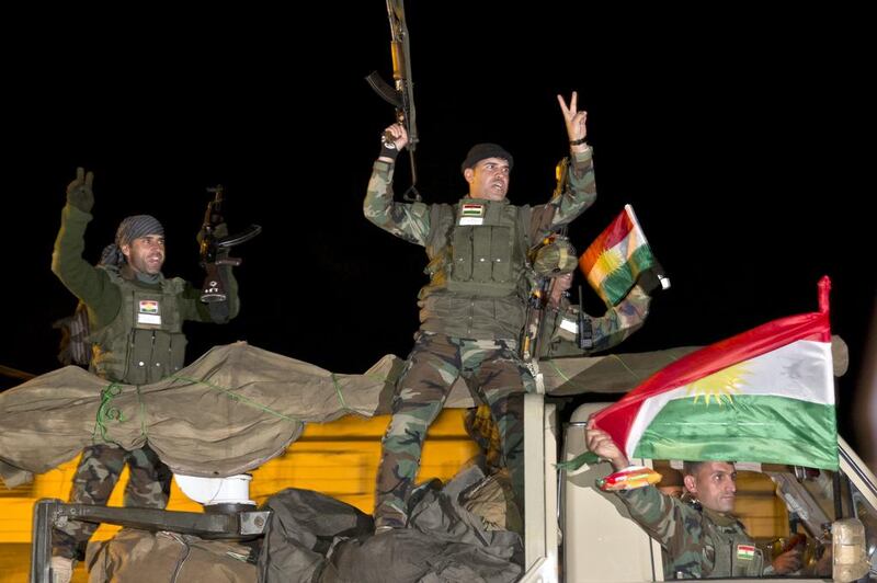 Iraqi Kurdish peshmerga fighters on their way to Kobani, also known as Ayn Arab, to fight ISIL (AP Photo/Vadim Ghirda)