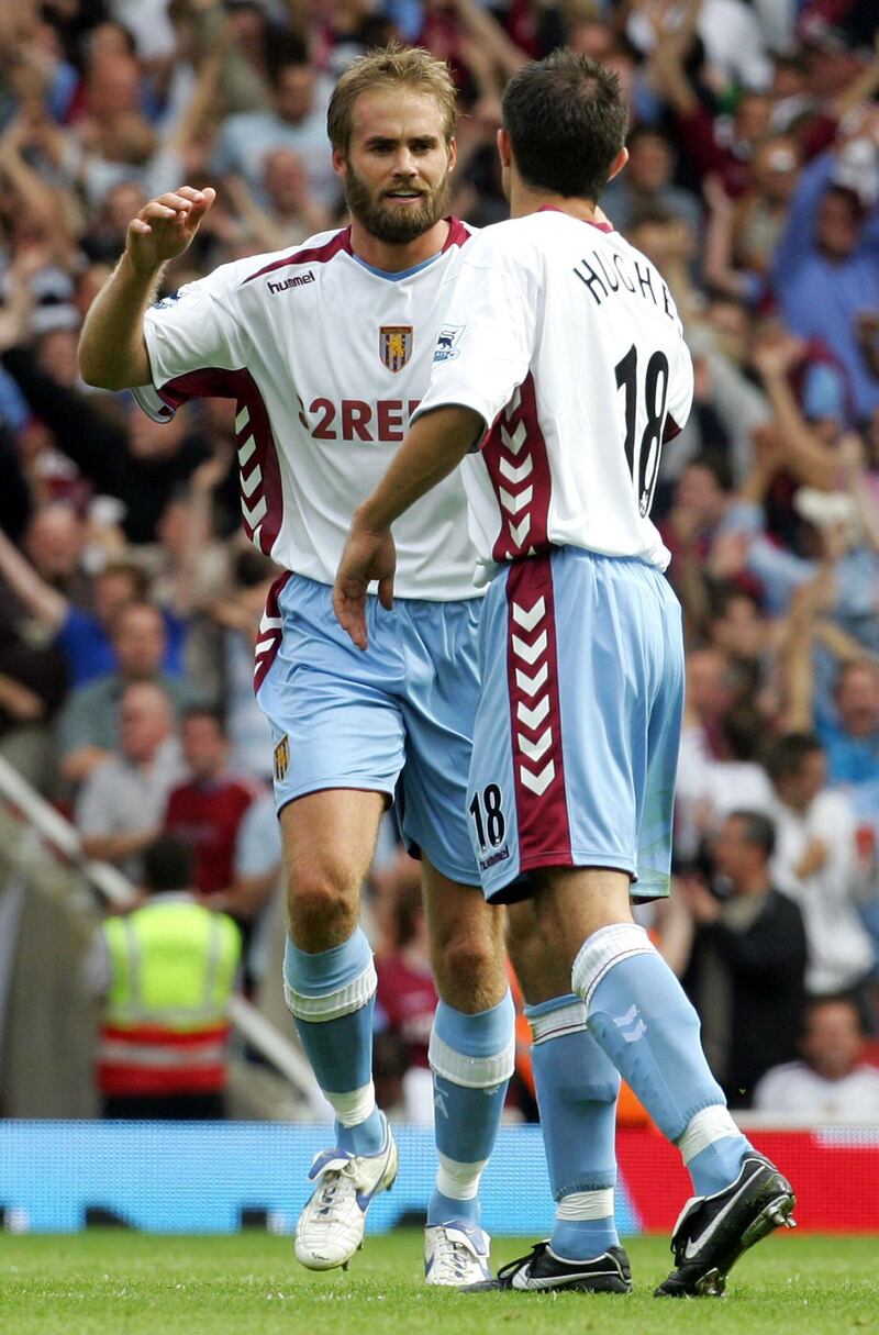 Aston Villa's Olof Mellberg (L) celebrates with teammate Aaron Hughes after scoring the first goal of the match during their first Premiership football match of the 2006/2007 season against Arsenal at the newly built Arsenal Emirates Stadium in London, 19 August 2006. The match ended 1-1. AFP PHOTO/CARL DE SOUZA. Mobile and website use of domestic English football pictures subject to description of licence with Football Association Premier League (FAPL). For licence enquiries please telephone +44 207 298 1656. For newspapers where the football content of the printed version and the electronic version are identical, no licence is needed. (Photo by CARL DE SOUZA / AFP)