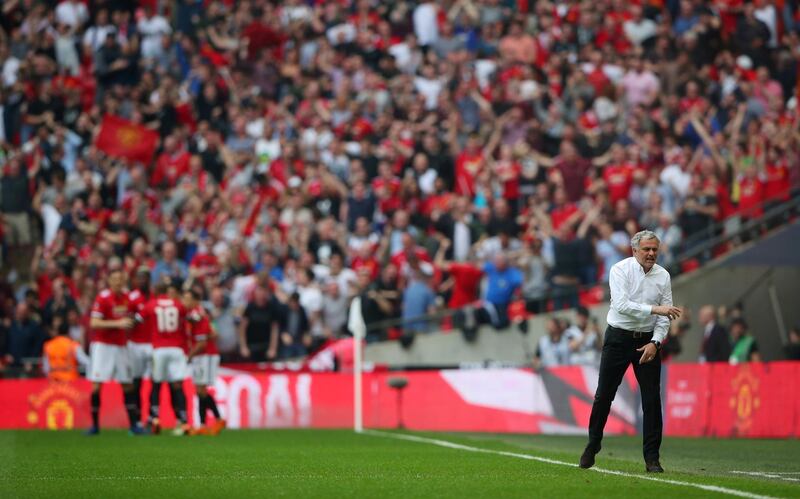 Soccer Football -  FA Cup Semi-Final - Manchester United v Tottenham Hotspur  - Wembley Stadium, London, Britain - April 21, 2018   Manchester United manager Jose Mourinho reacts as Alexis Sanchez celebrates scoring their first goal with team mates   REUTERS/Hannah McKay     TPX IMAGES OF THE DAY