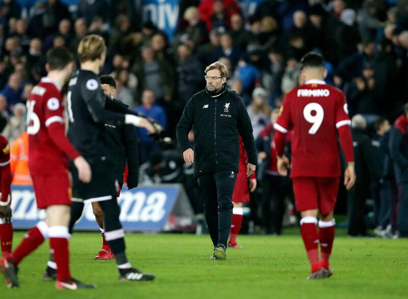 Liverpool manager Jurgen Klopp, centre, looks dejected, at the end of the English Premier League soccer match between Swansea City and Liverpool, at the Liberty Stadium, in Swansea, Wales, Monday, Jan. 22, 2018. (Nick Potts/PA via AP)