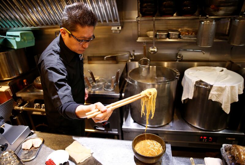 Kenji Saito cooks at his ramen noodle shop in Tokyo. Reuters
