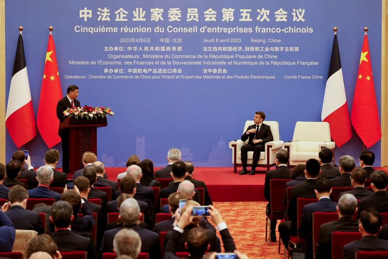 Mr Xi and Mr Macron during a Franco-Chinese business council meeting in Beijing. Reuters