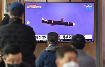 People watch a news broadcast on a North Korean missile test, at a railway station in Seoul on January 25, 2022. AFP
