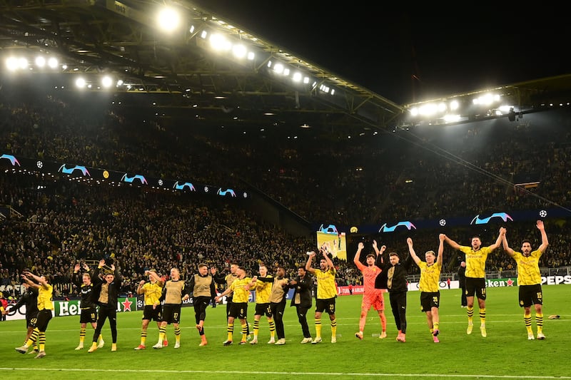 Dortmund's players celebrate in front of the fans after beating Atletico to reach the Champions League semi-finals. AFP