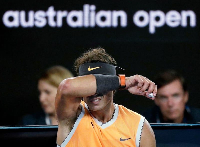 Spain's Rafael Nadal raises his arm to his head as he rest in his chair during a break in his match against Serbia's Novak Djokovic in the men's singles final at the Australian Open tennis championships in Melbourne, Australia, Sunday, Jan. 27, 2019. (AP Photo/Kin Cheung)