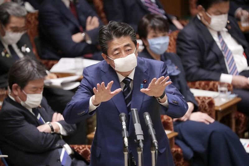 Japan's Prime Minister Shinzo Abe, wearing a face mask amid concerns over the spread of COVID-19 coronavirus, attends an upper house committee meeting at the parliament in Tokyo.   AFP