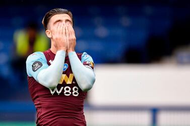 Aston Villa's English midfielder Jack Grealish reacts after missing a shot during the English Premier League football match between Everton and Aston Villa at Goodison Park in Liverpool, north west England on July 16, 2020. RESTRICTED TO EDITORIAL USE. No use with unauthorized audio, video, data, fixture lists, club/league logos or 'live' services. Online in-match use limited to 120 images. An additional 40 images may be used in extra time. No video emulation. Social media in-match use limited to 120 images. An additional 40 images may be used in extra time. No use in betting publications, games or single club/league/player publications. / AFP / POOL / PETER POWELL / RESTRICTED TO EDITORIAL USE. No use with unauthorized audio, video, data, fixture lists, club/league logos or 'live' services. Online in-match use limited to 120 images. An additional 40 images may be used in extra time. No video emulation. Social media in-match use limited to 120 images. An additional 40 images may be used in extra time. No use in betting publications, games or single club/league/player publications.