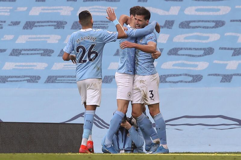 Manchester City's defender Ruben Dias, right, celebrates scoring the opening goal. AFP