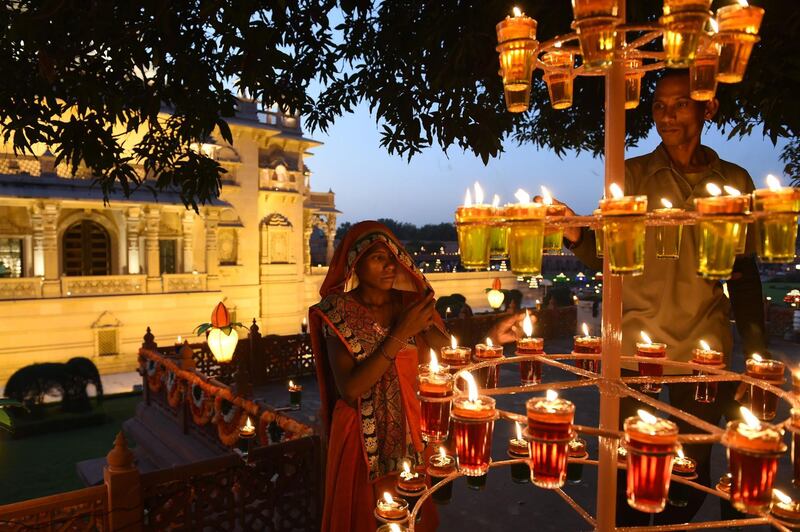 Indian workers light oil lamps during "Diwali" festival celebrations in Gandhinagar, about  30km from Ahmedabad. AFP