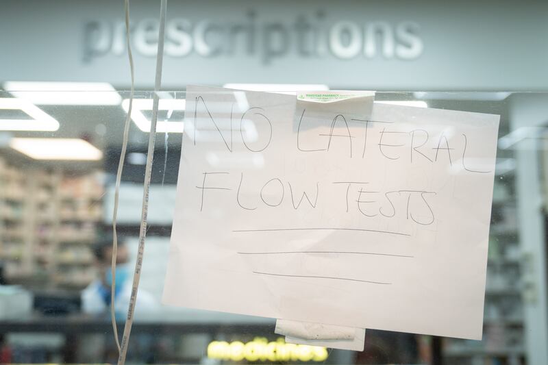 A sign advising customers that there are no lateral flow test kits available in the window of Wanstead Pharmacy in east London. PA