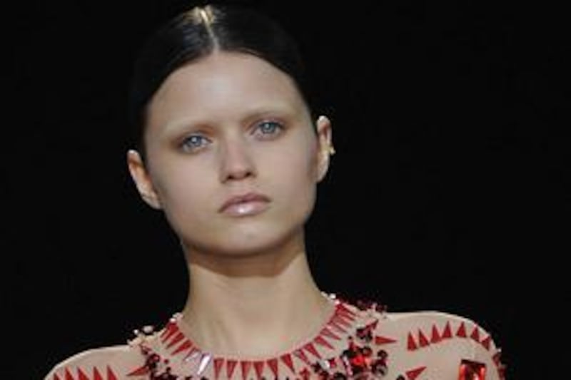 A model wit nearly invisible eyebrows struts down the catwalk during Givenchy's autumn/winter 2010 show in Paris.