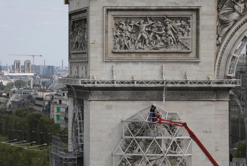 Workers are preparing the famed Paris monument for the project called 'L'Arc de Triomphe, Wrapped' by late artist Christo. AP