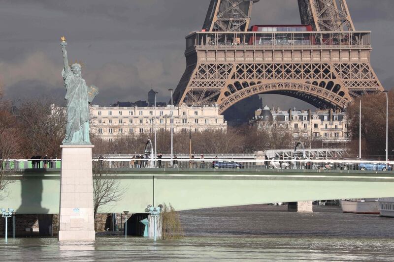 The flooded Ile aux Cygnes and banks of the river Seine with a model of the Statue of Liberty and the Eiffel Tower in the backround in Paris.
Leaks were starting to appear on January 26 in the basements of Paris buildings as the Seine inched higher, with forecasters warning that the river could stay high throughout next wee. Ludovic Marin / AFP