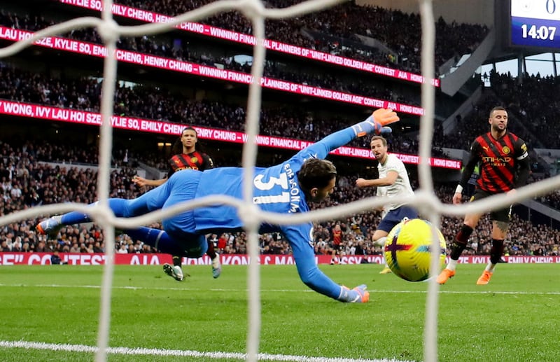 Tottenham Hotspur's Harry Kane scores past Manchester City goalkeeper Ederson. Reuters