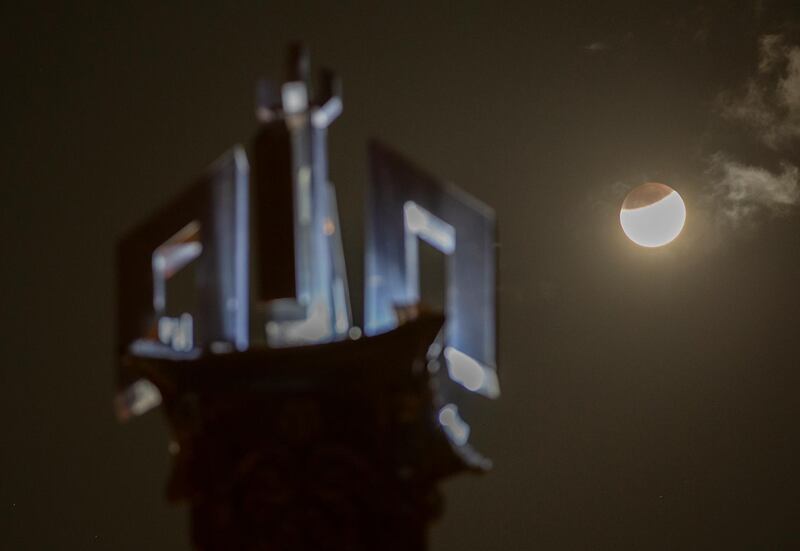 The moon rises against a tower with the name of God in Arabic "Allah," in Islamabad, Pakistan. AP Photo/B.K. Bangash