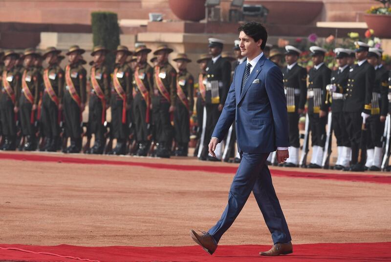 Mr Trudeau inspects a guard of honour during his ceremonial reception at the Indian Presidential Palace. Prakash Singh / AFP