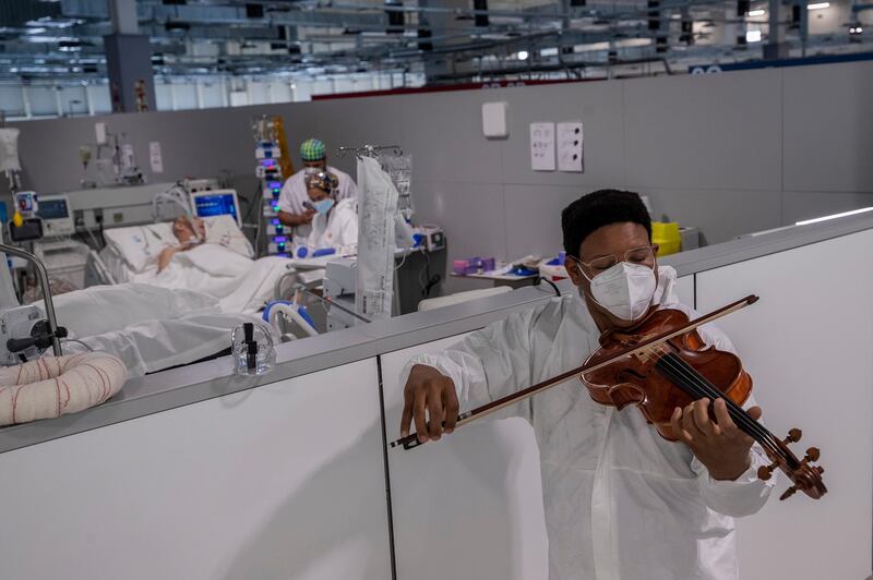 Musician Samuel Palomino plays the viola during a Mozart mini-concert for Covid-19 patients at the Nurse Isabel Zendal Hospital in Madrid, Spain. AP Photo