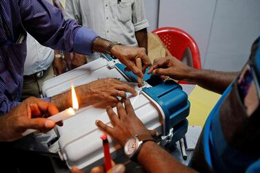Polling officials seal a Voter Verifiable Paper Audit Trail machine at a polling station after the end of the third phase of the general election in Kochi. Reuters