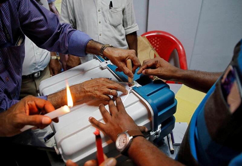 Polling officials seal a Voter Verifiable Paper Audit Trail (VVPAT) machine at a polling station after the end of the third phase of the general election in Kochi, India, April 23, 2019. REUTERS/Sivaram V
