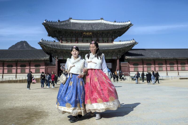 SEOUL, SOUTH KOREA - FEBRUARY 21:  Tourists wearing traditional Korean Hanbok dresses visit Gyeongbokgung Palace on February 21, 2018 in Seoul, South Korea. With tourists visiting from around the world, leaders from South Korea's capital as well as GyeongGi and Gangwon Provinces have agreed to work together to support the PyeongChang Olympic Games and to invigorate regional tourism.  (Photo by Carl Court/Getty Images)