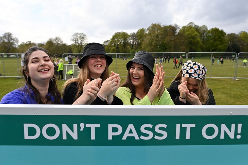 Concert-goers sanitise their hands as they arrive at the venue for the latest event in the government's Events Research programme, a live music concert hosted by Festival Republic in Sefton Park in Liverpool. AFP