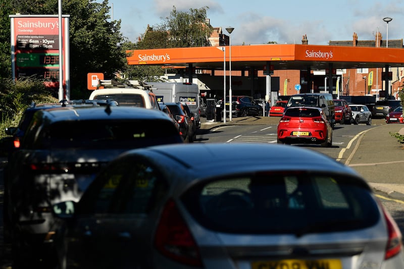 Motorists queue for petrol at a supermarket service station in Tonbridge, south-east England. Photo: AFP