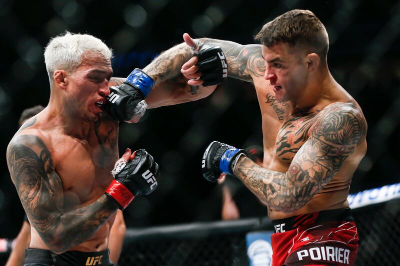 Charles Oliveira, left, fights Dustin Poirier. AP Photo