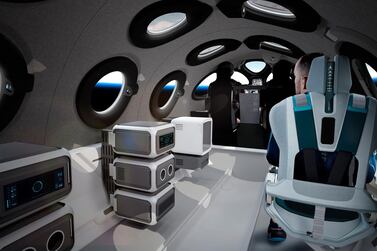 This undated photo released by Virgin Galactic shows the interior of their SpaceshipTwo Cabin during a flight. Highly detailed amenities to enhance the customer experience were shown in an online event Tuesday, July 28, 2020, revealing the cabin of the company's rocket plane, a type called SpaceShipTwo, which is undergoing testing in preparation for commercial service. There are a dozen windows for viewing, seats capable of being customized to each of six passengers and mood lighting. (Virgin Galactic via AP)
