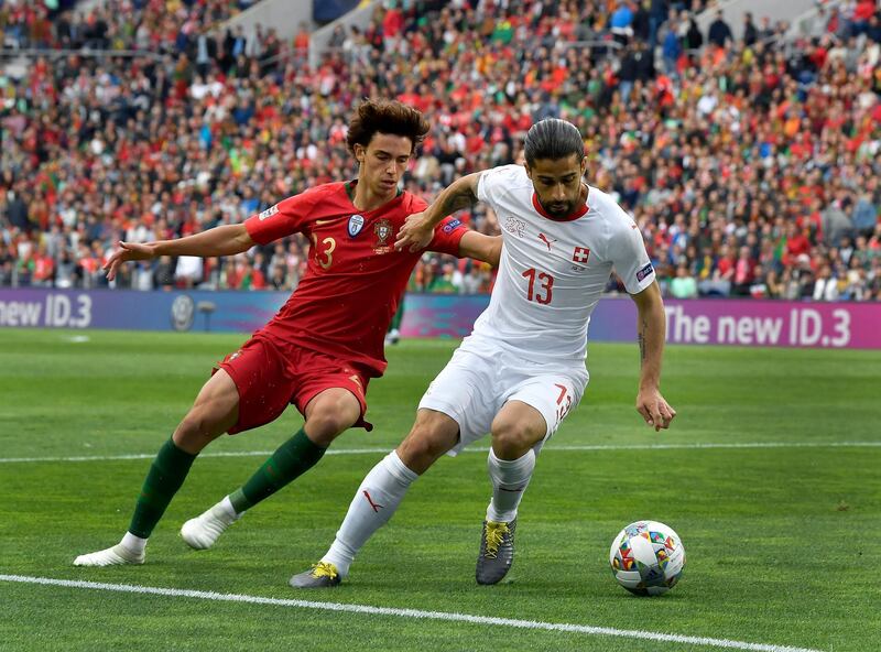 Portugal's Joao Felix, left, and Switzerland's Ricardo Rodriguez, right, challenge for the ball during the UEFA Nations League semifinal. AP Photo