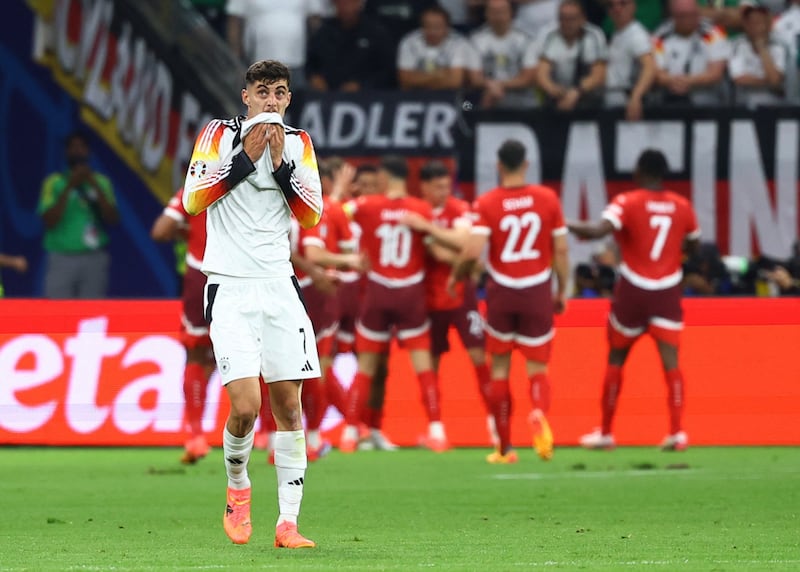 Germany's Kai Havertz reacts as Switzerland's Dan Ndoye celebrates scoring their first goal with teammates. Reuters