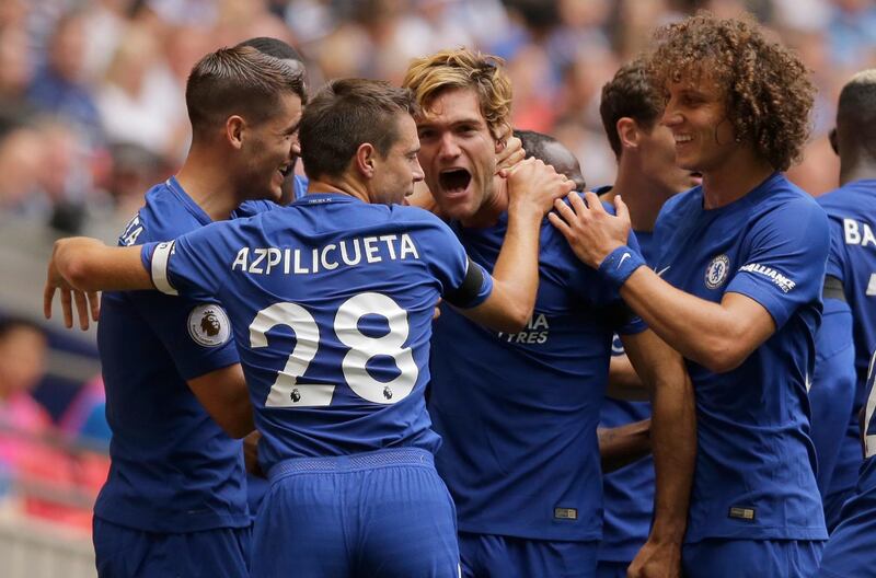Chelsea's Marcos Alonso, centre, celebrates with teammate Chelsea's Victor Moses after scoring the opening goal of the game during their English Premier League soccer match between Tottenham Hotspur and Chelsea at Wembley stadium in London, Sunday Aug. 20, 2017. (AP Photo/Alastair Grant)