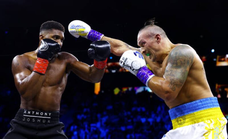 Anthony Joshua evades a punch from Oleksandr Usyk. Getty