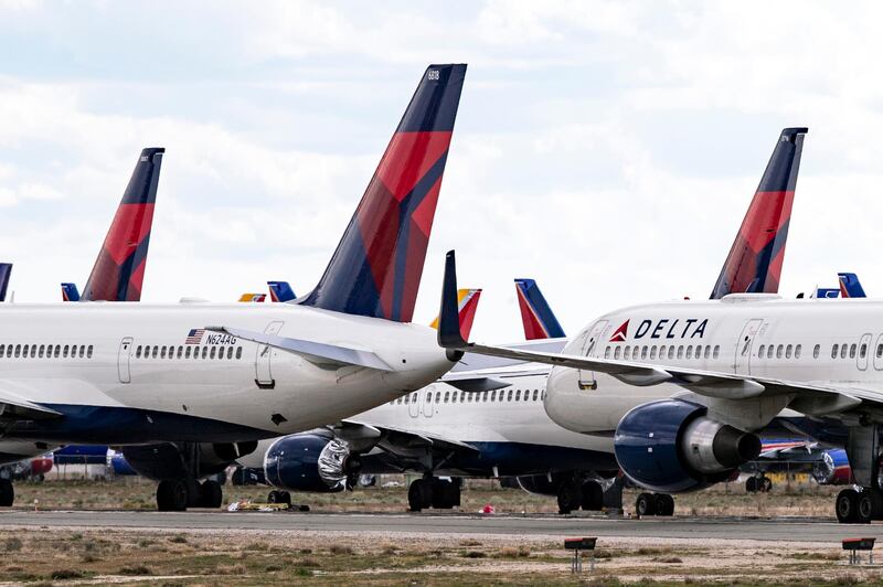 epa08325534 Delta Airlines planes are parked at the Southern California Logistics Airport among hundreds of other airplanes amid the coronavirus pandemic in Victorville, California, USA, 26 March 2020. In order to limit the spread of the COVID-19 coronavirus, big US carriers have announced plans to slash domestic flights by 30 percent and international flights by 75 percent, and some of the aircraft serving those routes may never return to service.  EPA-EFE/ETIENNE LAURENT