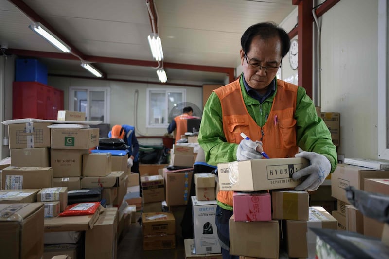 In a photo taken on May 10, 2018 Park Jae-yeol sorts his packages prior to delivering them, at an apartment complex in Seoul. In theory Park Jae-yeol should have retired 11 years ago. But despite its advanced-economy status, South Korea's pensions are meagre and the 71-year-old supplements his by delivering packages to high-rise apartments. Park is one of millions of elderly South Koreans pushed to labour well past retirement age in a rapidly-ageing society with weak social safety nets.
 - To go with SKorea-economy-population-social-demographics, FOCUS by Jung Hawon
 / AFP / Ed JONES / To go with SKorea-economy-population-social-demographics, FOCUS by Jung Hawon
